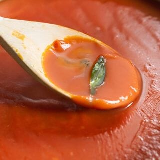 Creamy Tomato Basil Soup in spoon 